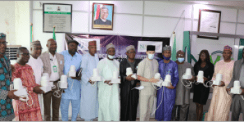 ICRISAT team presenting NiMet with cheap, recyclable IoT rain gauge prototypes conceived by Manobi Africa and Viveris to reduce basis risk, smallholder insurance premiums and loan rates (photo: NiMet/ICRISAT/Manobi Africa © May 2021)
